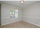 Bedroom with neutral walls, window, and trim work at 6020 Running Deer Rd, Charlotte, NC 28214