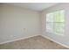 Bright bedroom featuring neutral walls, carpet flooring, and a window, creating a cozy and inviting atmosphere at 6020 Running Deer Rd, Charlotte, NC 28214