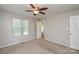 Bedroom featuring neutral walls, carpet flooring, ceiling fan and two windows, offering plenty of light at 6020 Running Deer Rd, Charlotte, NC 28214