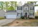 Charming two-story home with stone accents, black shutters and a two-car garage at 6020 Running Deer Rd, Charlotte, NC 28214
