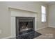 A fireplace with a black hearth and white mantel, with a window off to the side at 6020 Running Deer Rd, Charlotte, NC 28214