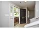 An open foyer with tile flooring, white walls, and a view of the front yard through the door at 6020 Running Deer Rd, Charlotte, NC 28214