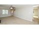 Spacious living room with a fireplace, neutral carpet, ceiling fan, a doorway and a large window at 6020 Running Deer Rd, Charlotte, NC 28214