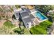 Aerial view of a home with solar panels, a pool, a well-manicured lawn, and surrounding landscaping at 6147 Lake Providence Ln, Charlotte, NC 28277