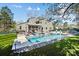 Beautiful backyard featuring a large swimming pool, patio furniture, lush green grass, and a well-maintained yard at 6147 Lake Providence Ln, Charlotte, NC 28277