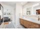 This bathroom features double sinks, wood cabinets and access to bedroom at 6147 Lake Providence Ln, Charlotte, NC 28277