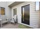 Charming front porch with seating area, complemented by a stylish black door and decorative welcome mat at 6147 Lake Providence Ln, Charlotte, NC 28277