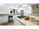 Modern kitchen with stainless steel appliances, white cabinetry, and an island cooktop, offering functionality at 6147 Lake Providence Ln, Charlotte, NC 28277