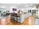 Open concept kitchen with white cabinets, island seating and hardwood floors at 6147 Lake Providence Ln, Charlotte, NC 28277