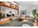 Bright living room with a loft area, hardwood floors, large sofa, area rug and stylish decor at 6147 Lake Providence Ln, Charlotte, NC 28277