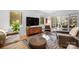 Sun-filled living room featuring hardwood floors, stylish furniture, and an entertainment center at 6147 Lake Providence Ln, Charlotte, NC 28277