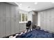 Spacious storage room with gray cabinetry, a desk area, and black and white flooring at 6147 Lake Providence Ln, Charlotte, NC 28277