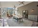 Relaxing sunroom featuring a ceiling fan, wood floors and walls, and furniture, with a view of the backyard at 6147 Lake Providence Ln, Charlotte, NC 28277