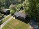 Charming single-Gathering home with a long driveway, surrounded by lush greenery and mature trees at 619 Center St, Gastonia, NC 28054