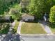 Aerial view of single-Gathering home surrounded by green lawns and mature trees in a residential area at 619 Center St, Gastonia, NC 28054