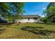 View of backyard with green grass and trees surrounding the back of the home at 619 Center St, Gastonia, NC 28054