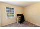 Bedroom with neutral carpet, a desk and chair, and a sunny window at 619 Center St, Gastonia, NC 28054