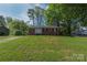Charming single-story brick home featuring a well-maintained lawn and mature trees at 619 Center St, Gastonia, NC 28054