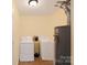 Functional laundry room with washer, dryer, and water heater at 619 Center St, Gastonia, NC 28054