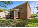 Brick home featuring a screened in porch overlooking an open green yard at 7798 Sand Trap Ln, Stanley, NC 28164