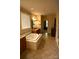Bathroom featuring a soaking tub, double vanity, tiled floors, and neutral colors at 7798 Sand Trap Ln, Stanley, NC 28164