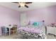 Bedroom with purple walls, carpet, a white door, a bed, and a desk at 7798 Sand Trap Ln, Stanley, NC 28164