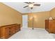 Bedroom featuring a ceiling fan, two dressers, neutral paint, and a white door at 7798 Sand Trap Ln, Stanley, NC 28164