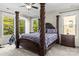 Bedroom with a four-poster bed, ceiling fan, carpet, and lots of natural light at 7798 Sand Trap Ln, Stanley, NC 28164