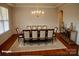 Elegant dining room featuring a chandelier, hardwood floors and decorative rug at 7798 Sand Trap Ln, Stanley, NC 28164