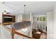 Open-concept living room boasts hardwood floors and abundant natural light from large windows, perfect for relaxation at 7798 Sand Trap Ln, Stanley, NC 28164