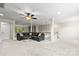 Bright living room with carpet, a ceiling fan, and neutral colors throughout at 7798 Sand Trap Ln, Stanley, NC 28164