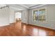 Bright living room with hardwood floors, natural light, and an open entryway at 7798 Sand Trap Ln, Stanley, NC 28164