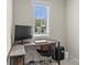 Home office with desk, monitor, neutral colors, and a bright window at 7798 Sand Trap Ln, Stanley, NC 28164