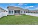 Large backyard with a well-maintained lawn, a covered patio, and a white vinyl fence at 7850 Fountaingrass Ln, Sherrills Ford, NC 28673