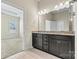 Bathroom featuring double vanity, granite countertop, ceramic tile floor, and ensuite access at 7850 Fountaingrass Ln, Sherrills Ford, NC 28673