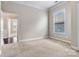 Neutral bedroom showcasing a window with blinds and neutral carpeting at 7850 Fountaingrass Ln, Sherrills Ford, NC 28673