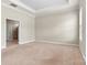 Spacious bedroom with tray ceiling, plush carpet, and an en-suite bathroom at 7850 Fountaingrass Ln, Sherrills Ford, NC 28673