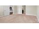 Bedroom featuring plush carpet, neutral walls, and an open doorway leading to other rooms at 7850 Fountaingrass Ln, Sherrills Ford, NC 28673