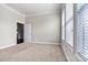 Spacious bedroom featuring plush carpet, neutral walls, and an open doorway at 7850 Fountaingrass Ln, Sherrills Ford, NC 28673