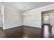 A formal dining room features wainscoting, dark wood floors, and a modern chandelier at 7850 Fountaingrass Ln, Sherrills Ford, NC 28673