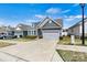 Attractive home with a two-car garage, complemented by a manicured lawn and inviting facade at 7850 Fountaingrass Ln, Sherrills Ford, NC 28673