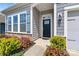 Welcoming front entrance features a stylish door, decorative stone accents, and lush landscaping at 7850 Fountaingrass Ln, Sherrills Ford, NC 28673