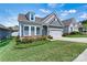 Charming single-Gathering home featuring a well-manicured lawn, classic curb appeal, and an attached garage at 7850 Fountaingrass Ln, Sherrills Ford, NC 28673