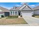 Charming single-story home featuring a two-car garage, manicured lawn, and inviting curb appeal at 7850 Fountaingrass Ln, Sherrills Ford, NC 28673