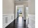 Inviting hallway with rich hardwood floors, detailed trim, and a view of the bright front exterior at 7850 Fountaingrass Ln, Sherrills Ford, NC 28673