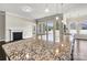 Modern kitchen with stainless steel appliances and granite counters, featuring an island and fireplace views at 7850 Fountaingrass Ln, Sherrills Ford, NC 28673