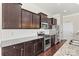 Well-equipped kitchen featuring granite countertops, stainless steel appliances, and dark wood cabinetry at 7850 Fountaingrass Ln, Sherrills Ford, NC 28673