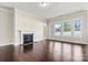 Bright living room with hardwood floors, fireplace, and large windows offering a view of the outdoors at 7850 Fountaingrass Ln, Sherrills Ford, NC 28673