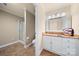 Well-lit bathroom featuring a glass enclosed shower and a vanity with ample storage at 7980 Bradford Ln, Denver, NC 28037