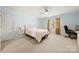Bedroom with light blue walls, carpet flooring, a ceiling fan, and natural light at 7980 Bradford Ln, Denver, NC 28037